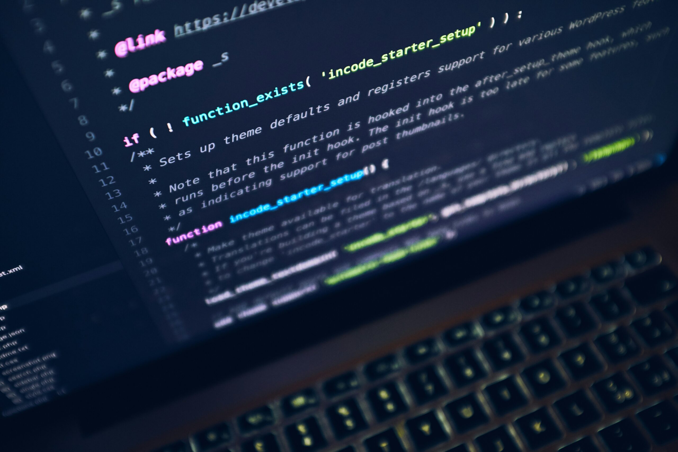 Écran de laptop affichant du code, ambiance sombre et professionnelle